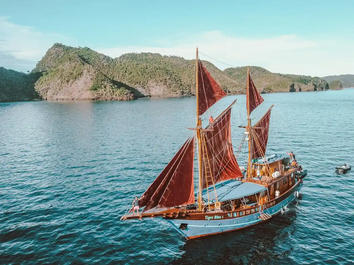 A charter boat anchored off a tropical island