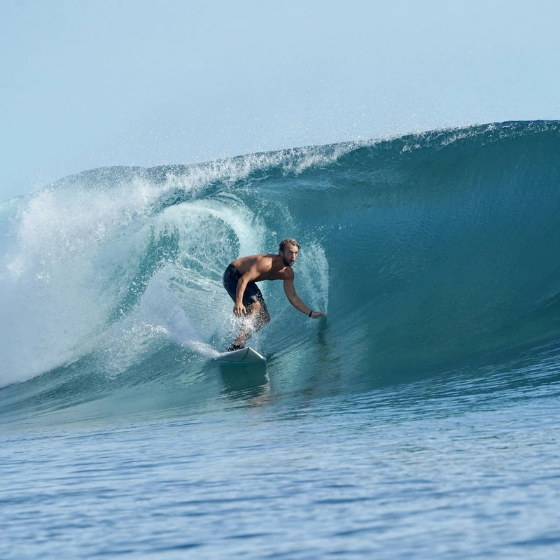 Surfer deep in the barrel of a Mentawai reef wave