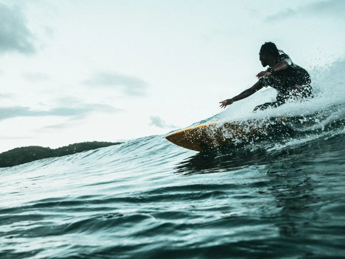 A surfer riding a clean tropical wave