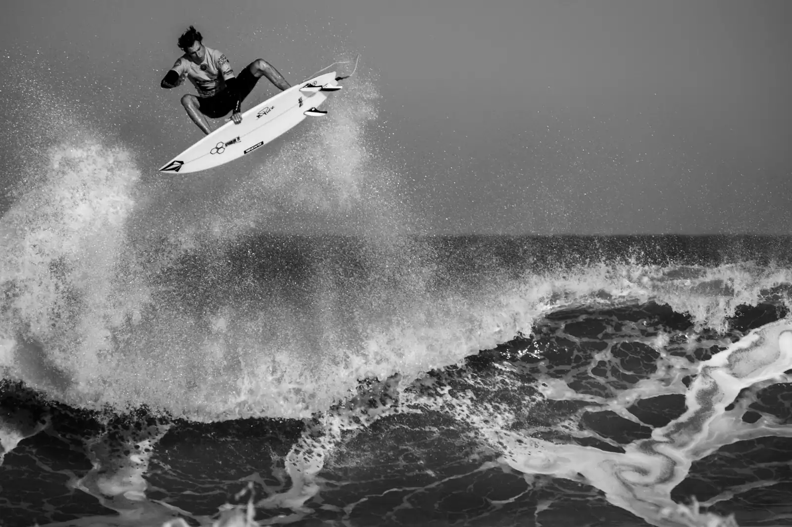 Advanced surfer performing an aerial trick on a Mentawai wave