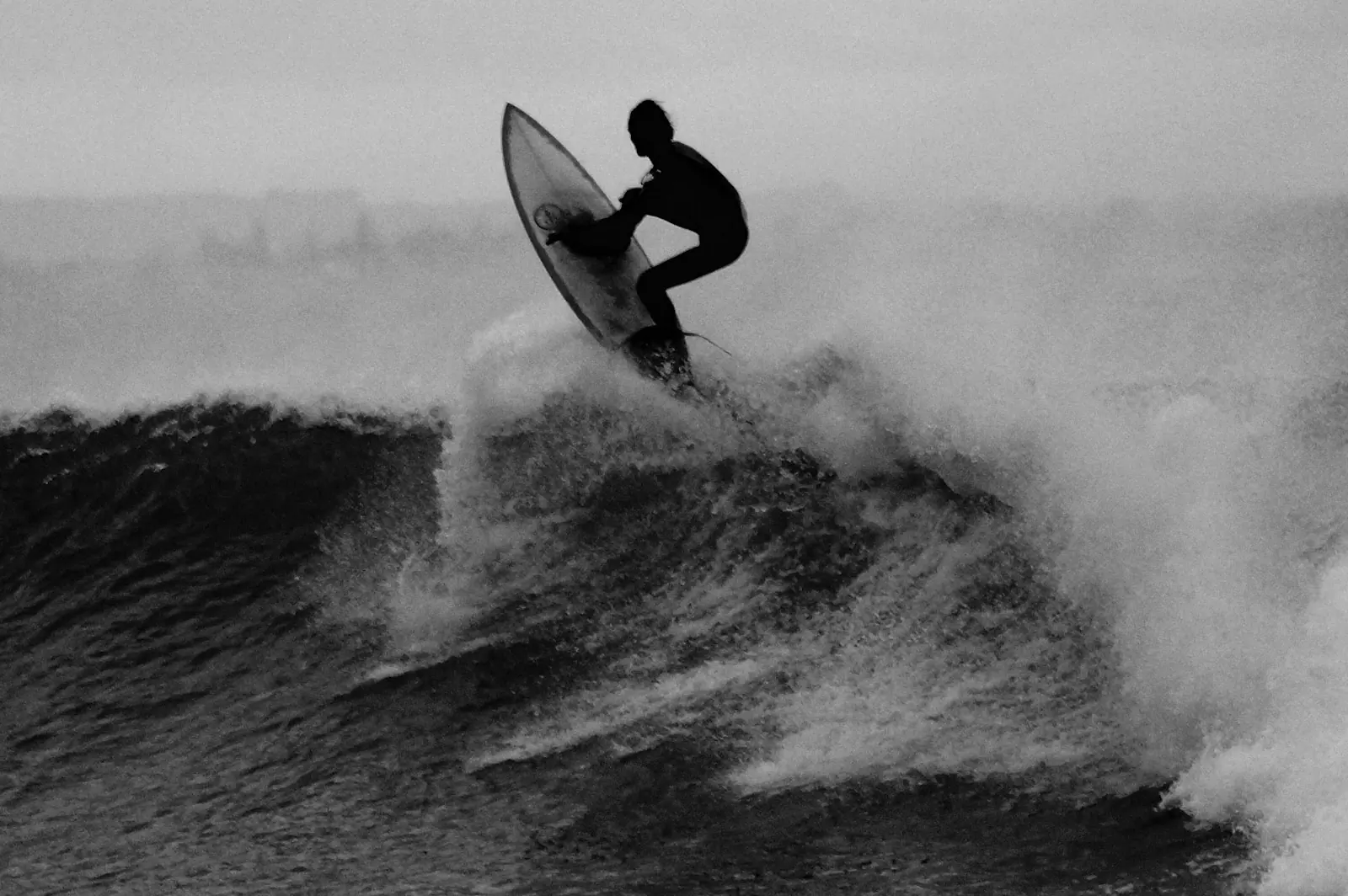 Surfer catching air at Pitstops surf break in the Playgrounds area, Mentawai