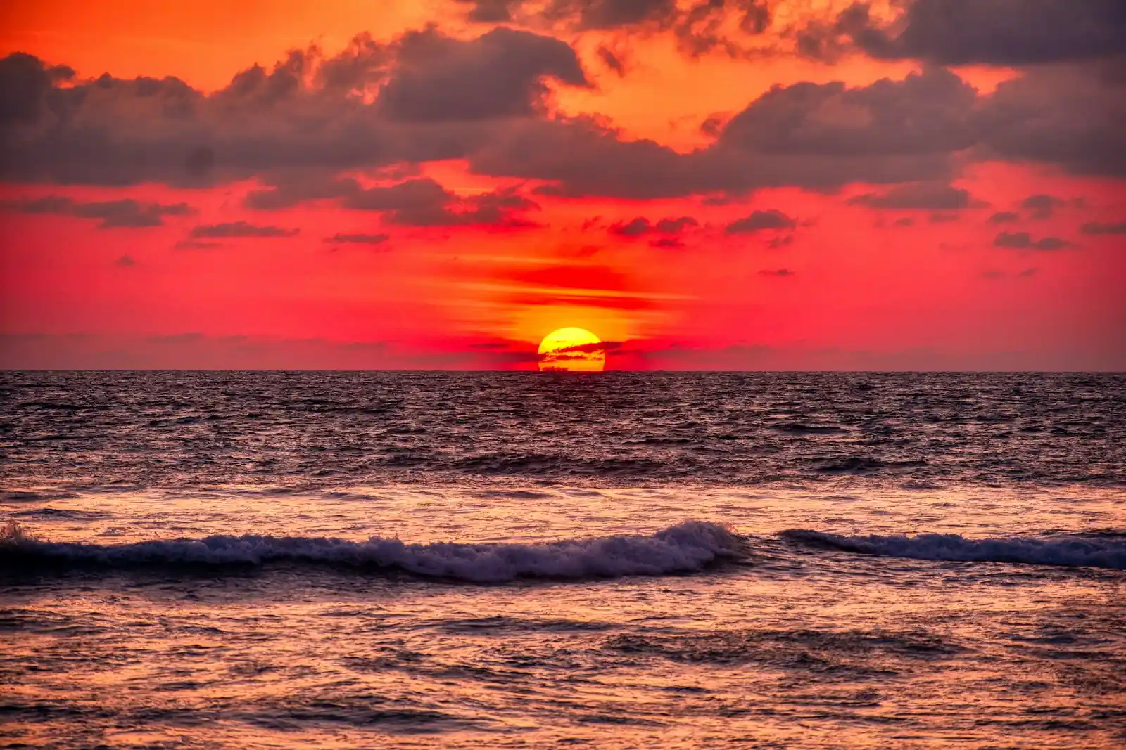 Sunset over surf waves during the best season to visit Mentawai