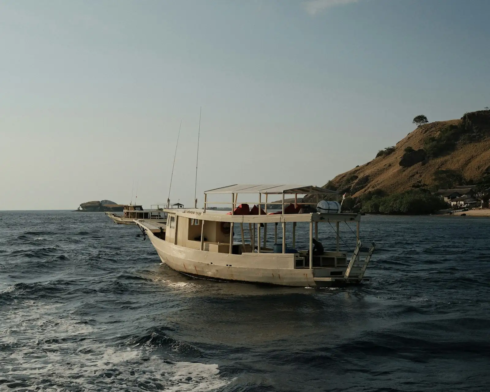 Traditional Mentawai surf charter boat near the coastline