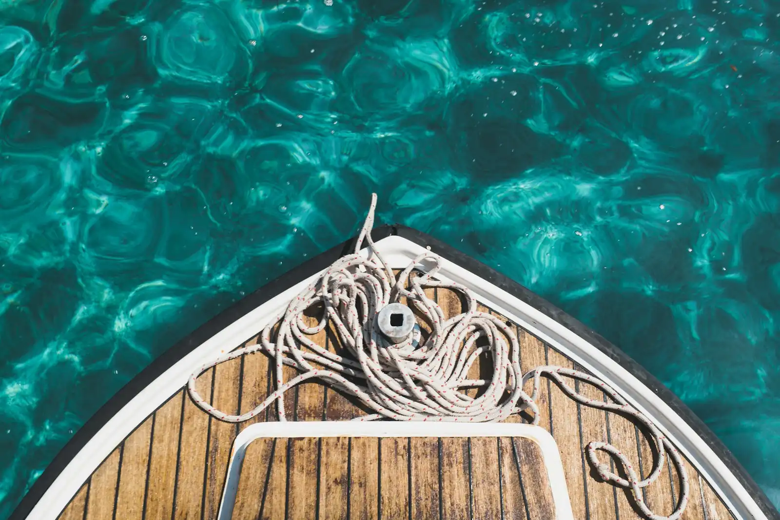 Bow of a liveaboard charter boat on clear water in Mentawai
